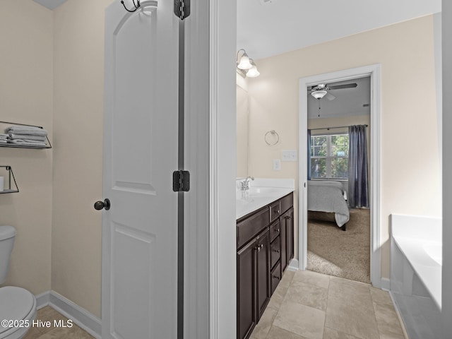 ensuite bathroom featuring toilet, ensuite bathroom, a garden tub, tile patterned flooring, and vanity