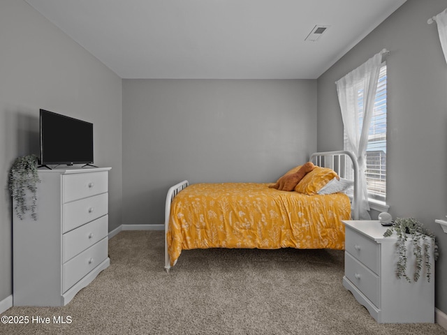 bedroom with light carpet, visible vents, and baseboards