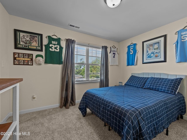 carpeted bedroom with visible vents and baseboards