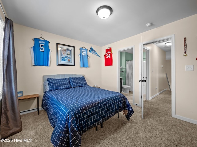 bedroom featuring carpet flooring, baseboards, and ensuite bathroom