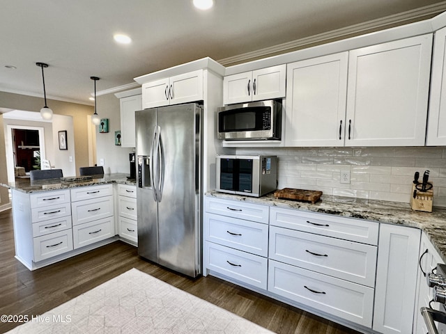 kitchen with white cabinets, appliances with stainless steel finishes, dark wood-style flooring, a peninsula, and crown molding