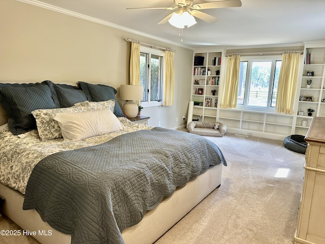 bedroom with carpet floors, ceiling fan, and crown molding