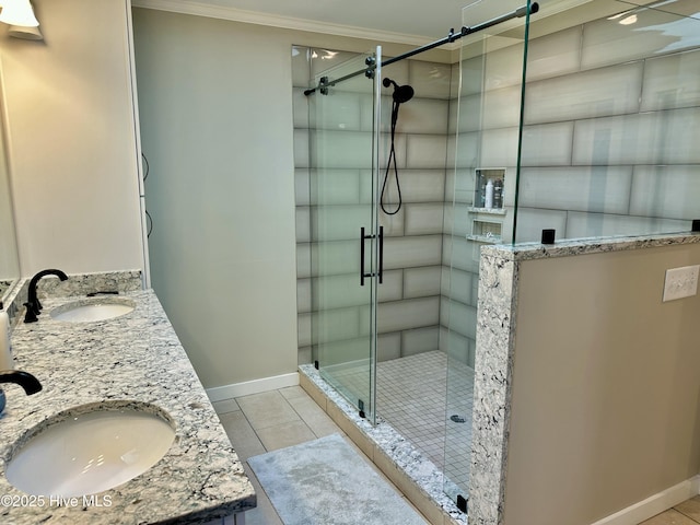 full bathroom featuring ornamental molding, a stall shower, and a sink