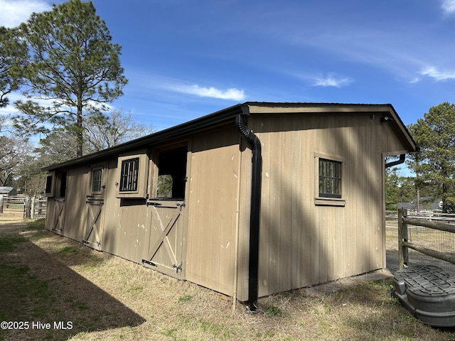 exterior space featuring an outdoor structure and fence