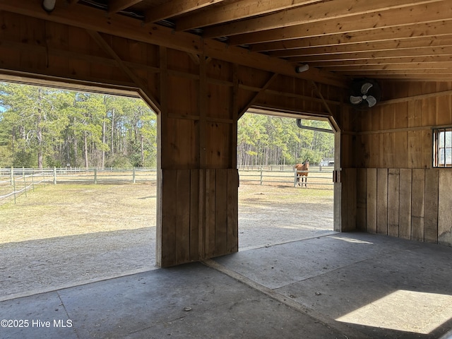 view of stable featuring a rural view and a wooded view