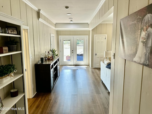 doorway featuring ornamental molding, french doors, and wood finished floors