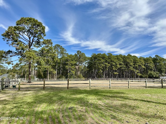 view of yard with an enclosed area and a rural view