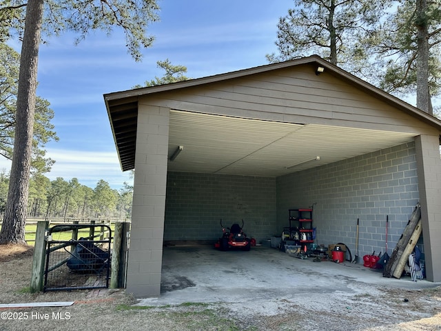 garage featuring a gate and a carport