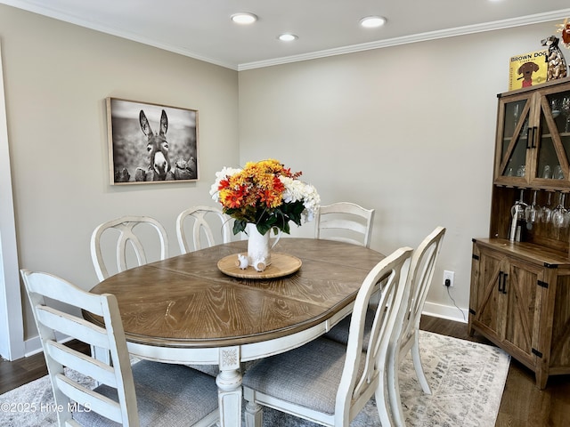 dining room with baseboards, ornamental molding, dark wood-type flooring, and recessed lighting