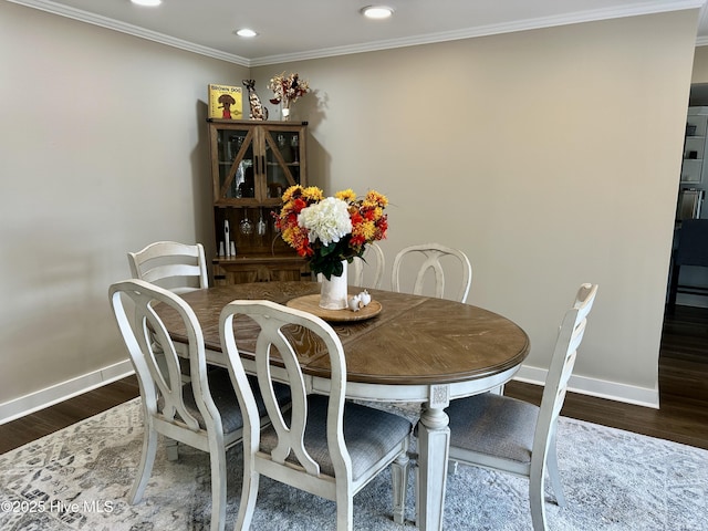 dining space featuring crown molding, baseboards, wood finished floors, and recessed lighting