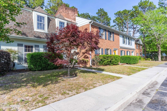 4937 Marlin Ct, Wilmington, NC 28403 - view of front of home featuring a front yard, brick siding, and a chimney