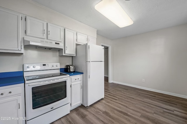 kitchen featuring dark wood-style flooring, white cabinetry, white appliances, under cabinet range hood, and baseboards