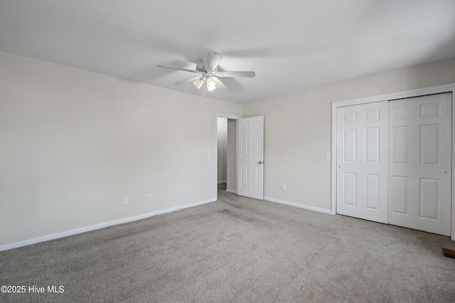 unfurnished bedroom featuring carpet, a closet, ceiling fan, a textured ceiling, and baseboards