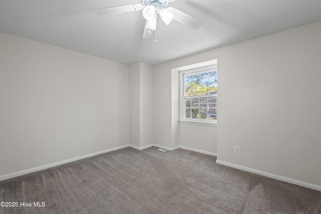 carpeted spare room with baseboards and ceiling fan