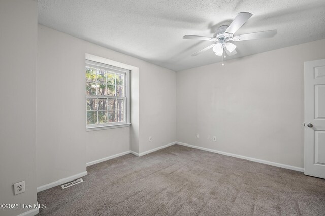 unfurnished bedroom with a textured ceiling, ceiling fan, carpet flooring, baseboards, and a closet