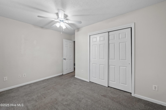 unfurnished bedroom featuring a textured ceiling, baseboards, carpet, a ceiling fan, and a closet