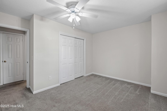 unfurnished bedroom featuring carpet floors, a closet, and baseboards