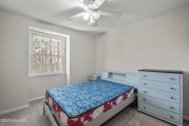 bedroom with carpet floors, baseboards, and a ceiling fan