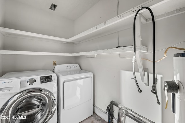 clothes washing area with washer and dryer and laundry area