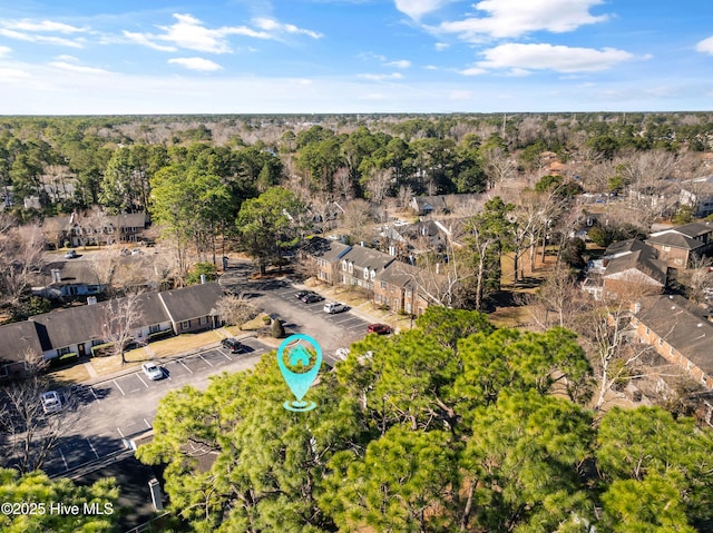 drone / aerial view featuring a forest view