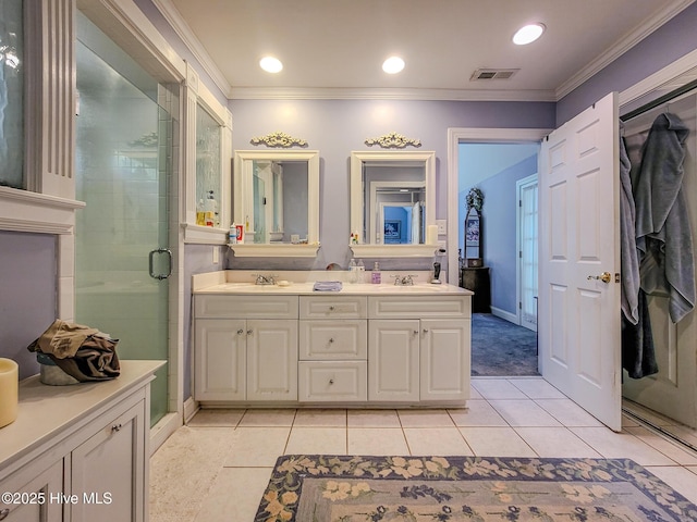 full bathroom featuring crown molding, a sink, a shower stall, and tile patterned floors