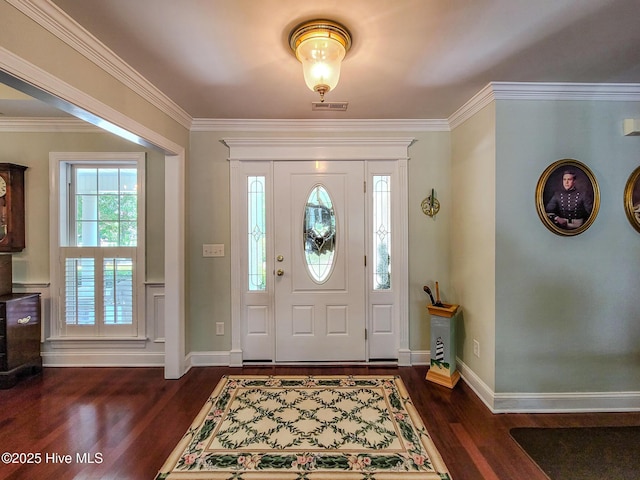 entrance foyer featuring dark wood-type flooring, visible vents, crown molding, and baseboards