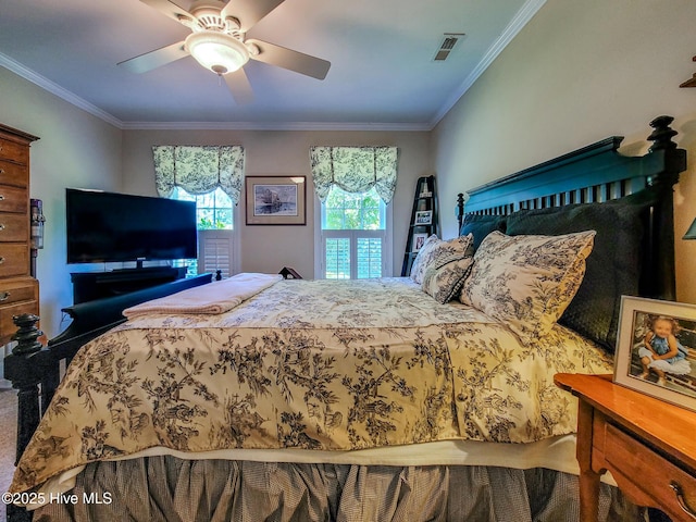 bedroom with ceiling fan, visible vents, and crown molding