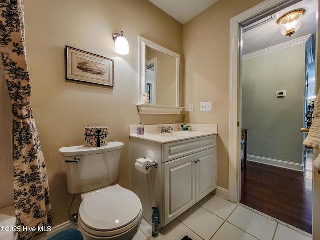 bathroom with baseboards, toilet, tile patterned floors, curtained shower, and vanity