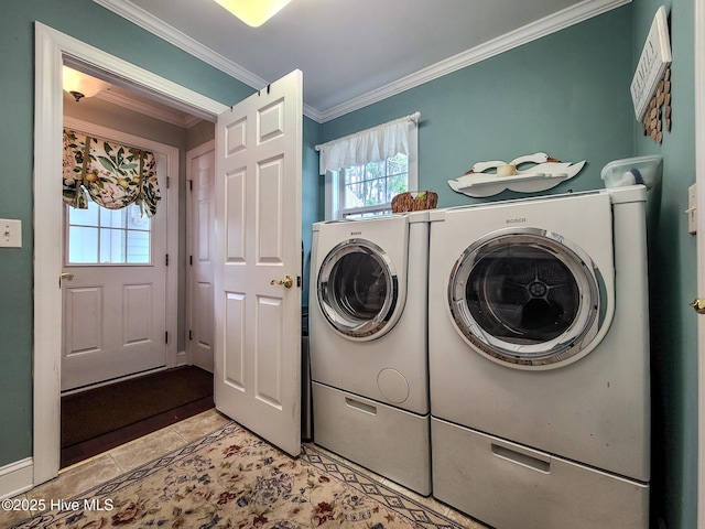 washroom with ornamental molding, separate washer and dryer, and light tile patterned floors