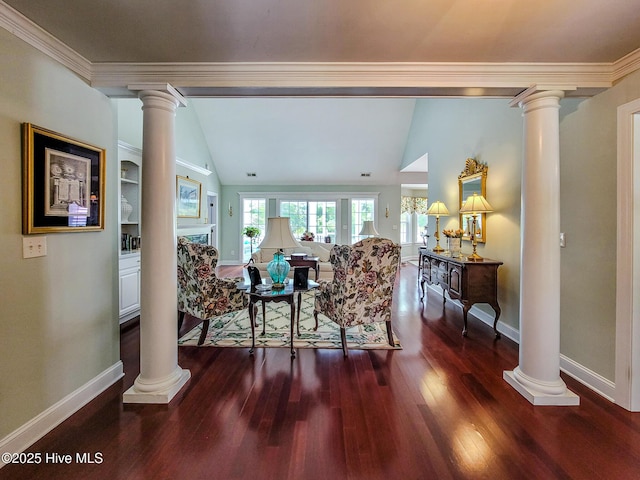 living room featuring baseboards, vaulted ceiling, wood finished floors, and ornate columns