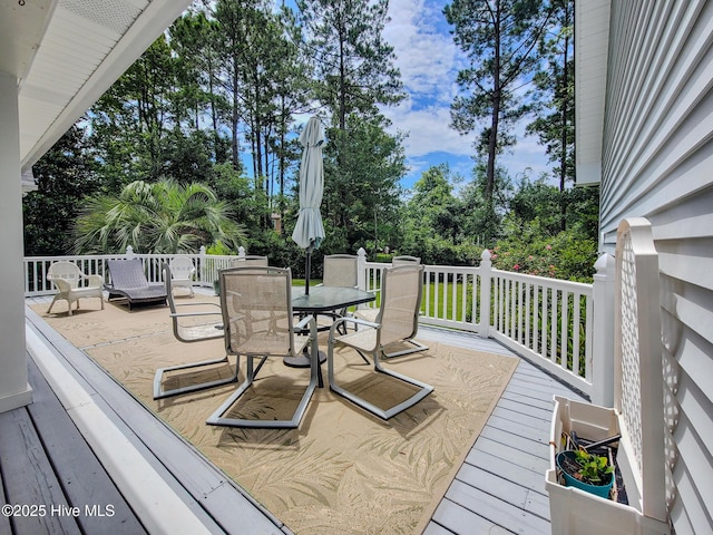 wooden terrace featuring outdoor dining area