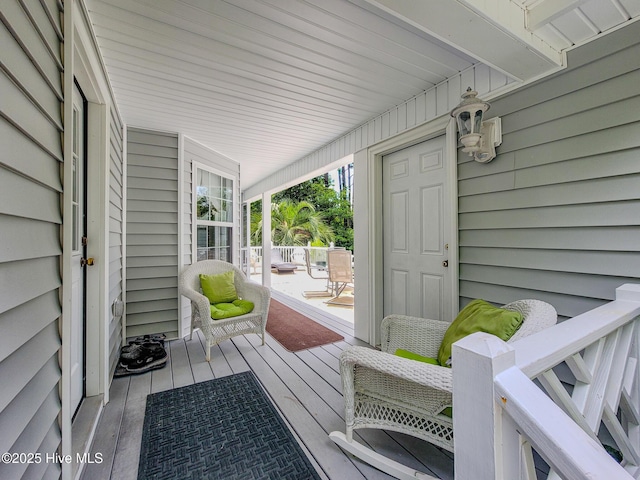 wooden terrace with a porch