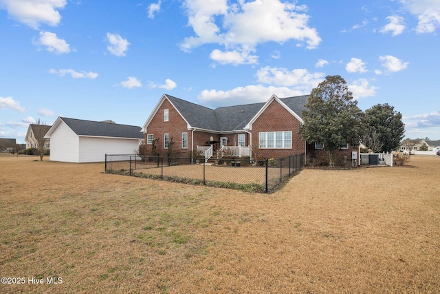 view of front facade featuring a front yard, brick siding, and fence private yard