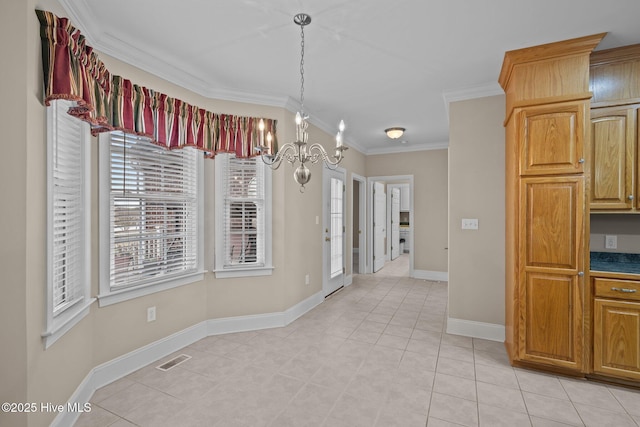 dining room featuring visible vents, crown molding, baseboards, and an inviting chandelier