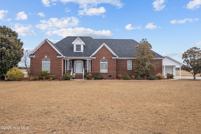 traditional-style house with brick siding, a front lawn, and an attached garage