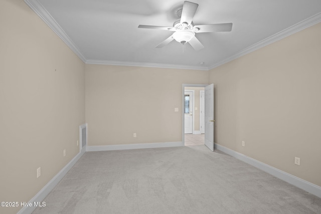 empty room with light carpet, baseboards, visible vents, ceiling fan, and ornamental molding