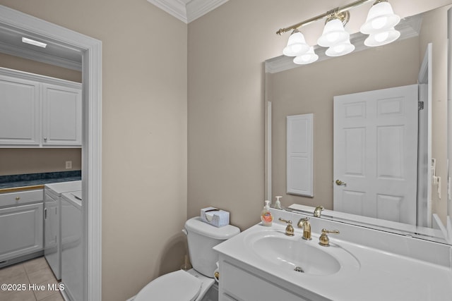 bathroom featuring a notable chandelier, washer and clothes dryer, ornamental molding, vanity, and tile patterned flooring