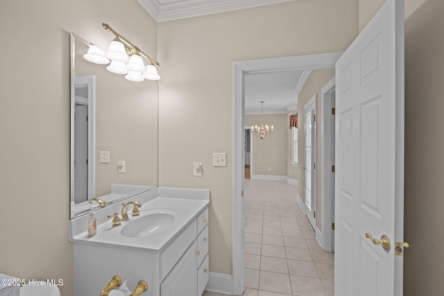 bathroom with crown molding, an inviting chandelier, vanity, tile patterned flooring, and baseboards