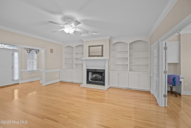 unfurnished living room with light wood-style flooring, baseboards, a fireplace with raised hearth, and crown molding