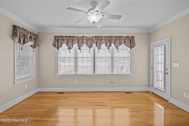 empty room featuring visible vents, baseboards, ceiling fan, crown molding, and light wood-style floors