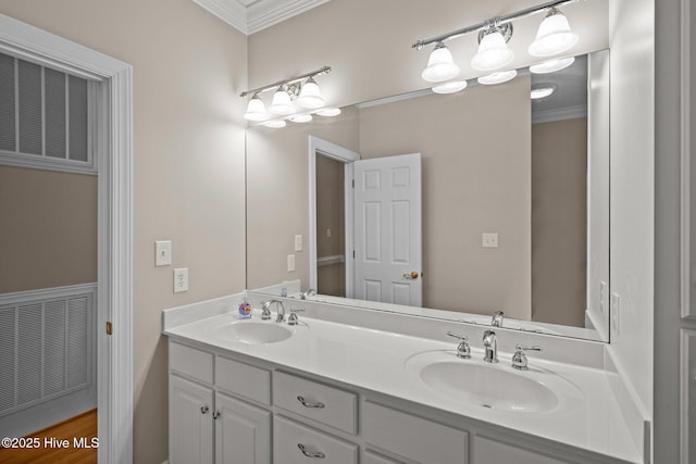 full bath with a sink, visible vents, and crown molding