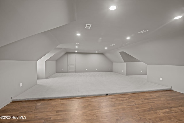 additional living space featuring lofted ceiling, visible vents, wood finished floors, and recessed lighting