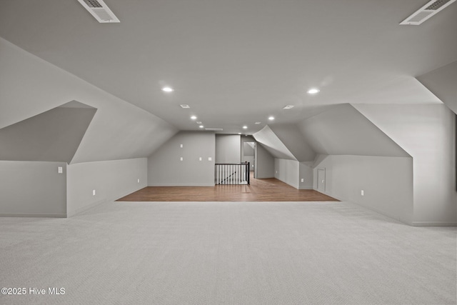 bonus room featuring lofted ceiling, visible vents, light carpet, and recessed lighting