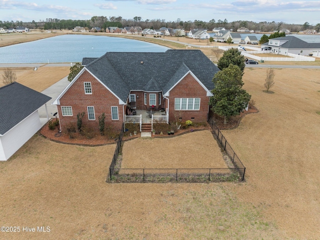 view of front of property featuring fence private yard, brick siding, roof with shingles, crawl space, and a residential view