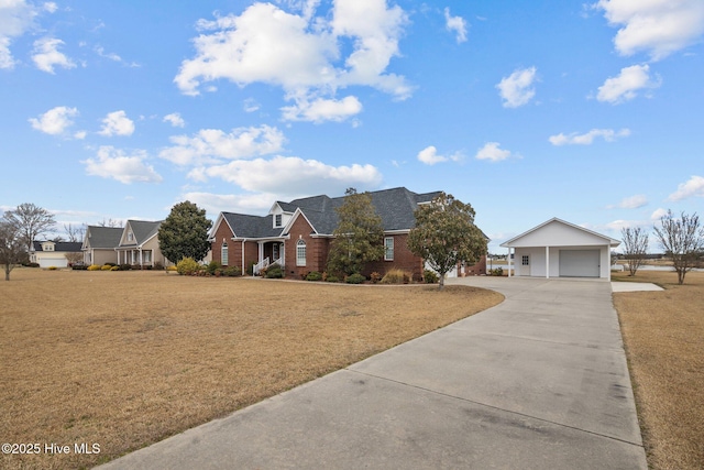 view of front of property with a garage, driveway, brick siding, and a front yard