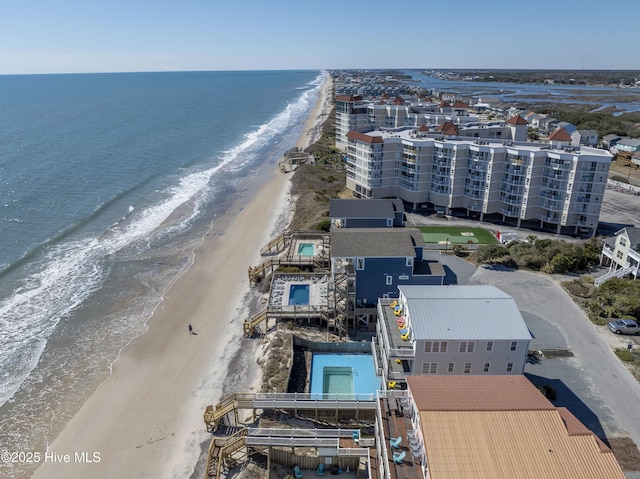 birds eye view of property with a water view and a view of the beach