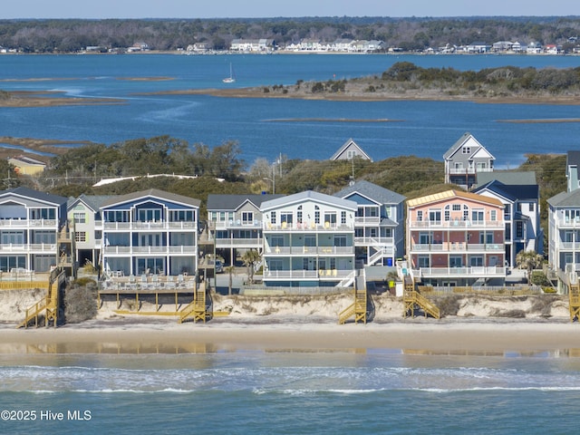 drone / aerial view with a water view and a view of the beach