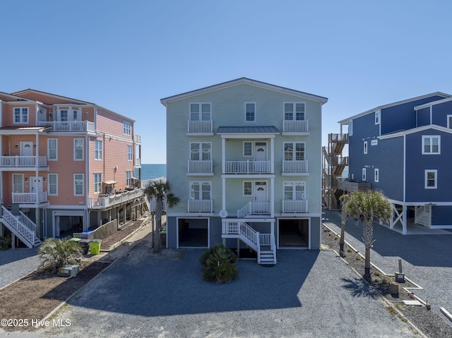 view of front facade featuring driveway, stairway, and an attached garage