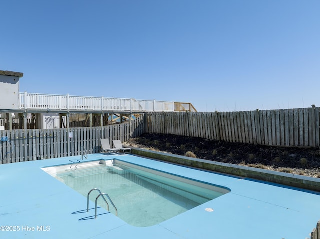 view of swimming pool featuring a fenced backyard