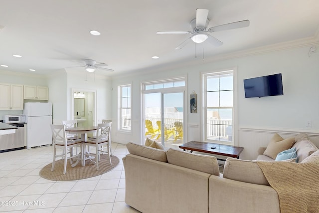 living room with plenty of natural light, ornamental molding, and light tile patterned flooring